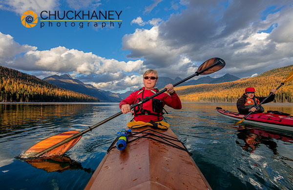 Sea kayaking in late autumn light on Bowman Lake in Glacier National Park, Montana, USA model released