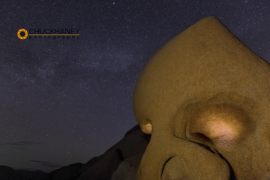 Skull Rock lit up at night in Joshua Tree National Park, California, USA