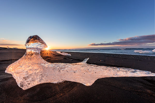 Scattered ice from icebergs on black sand beach at Joklusarlon, Iceland
