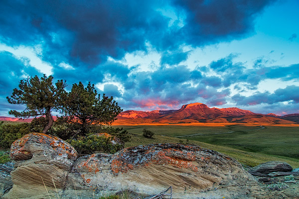 Fiery sunrise light strikes Ear Mountain along the Rocky Mountain Front near Choteau, Montana