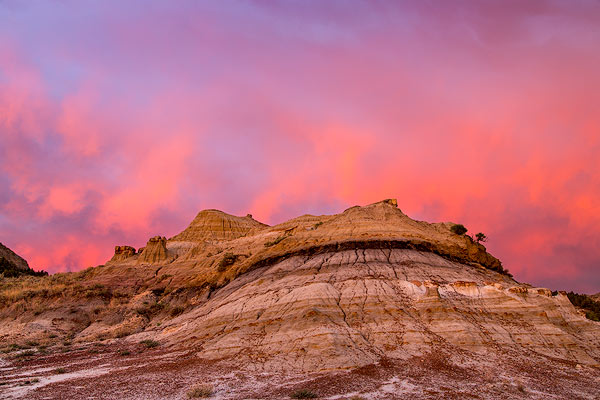 Fiery sunrise clouds over badlands at dawn in Theodore Roosevelt National Park, North Dakota, USA